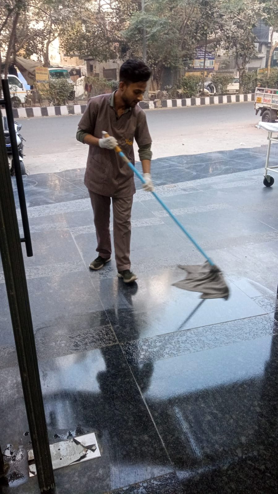 Staff mopping a lobby floor